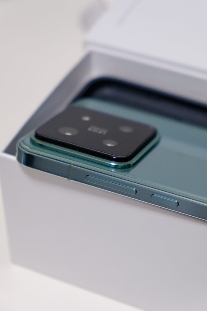 why-choose-us Detailed view of a sleek smartphone in its packaging, showcasing the camera module.